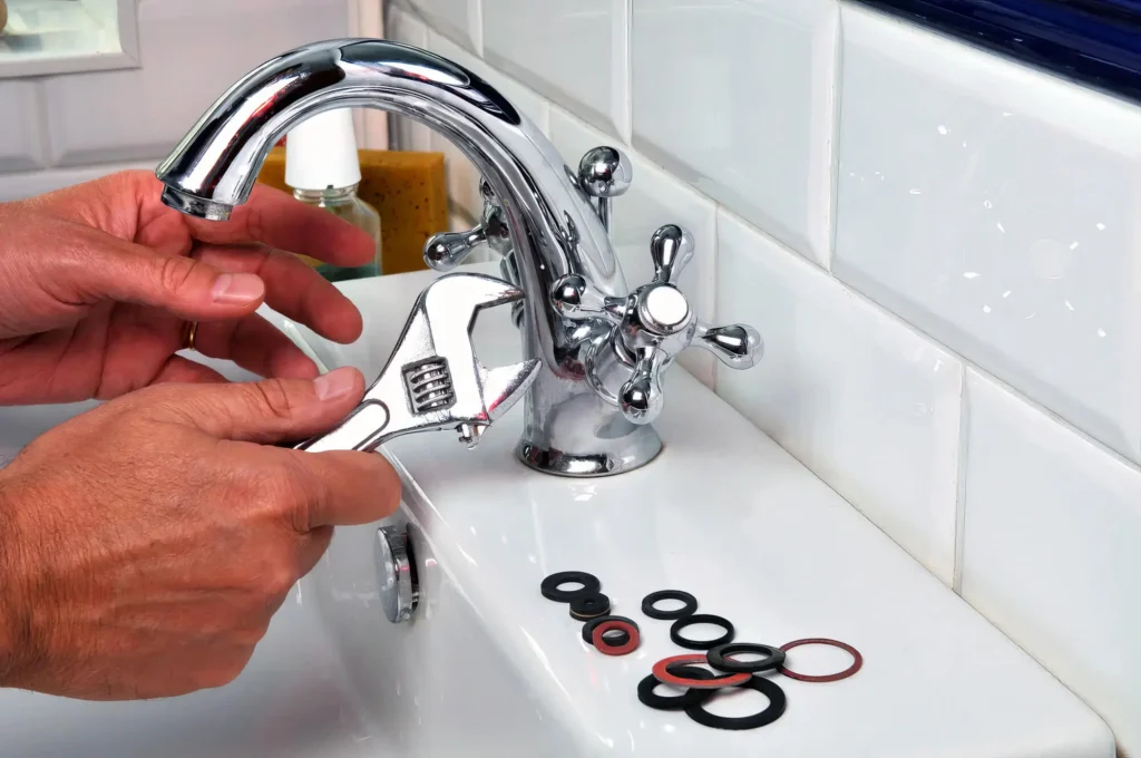 Plumber performing maintenance on a bathroom faucet in Rockledge