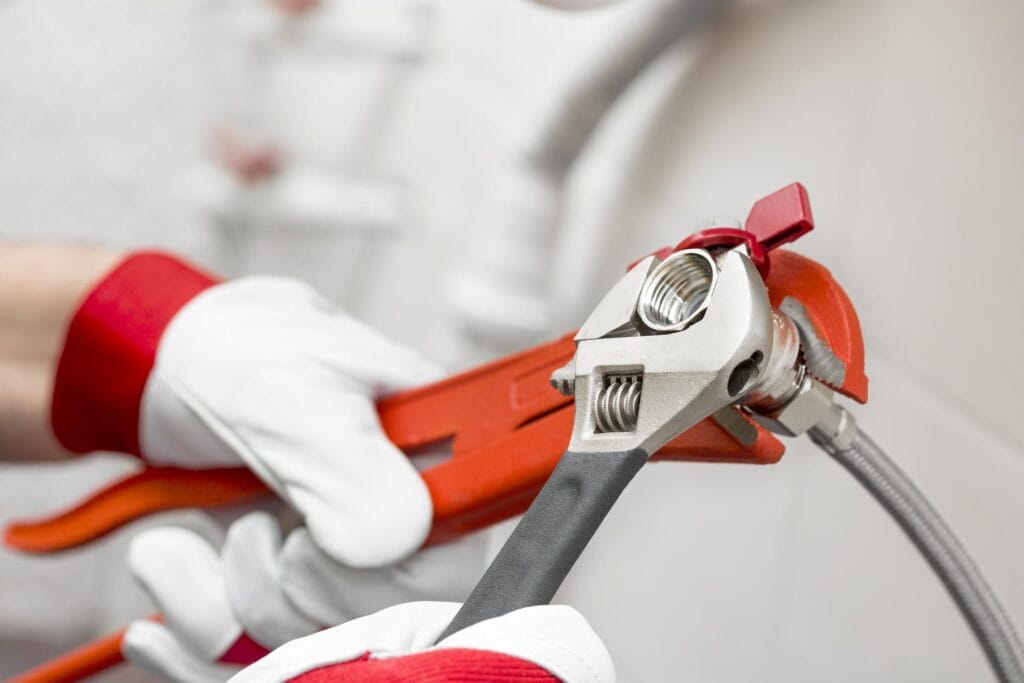 Plumber holding pipe wrenches for an emergency repair in Rockledge