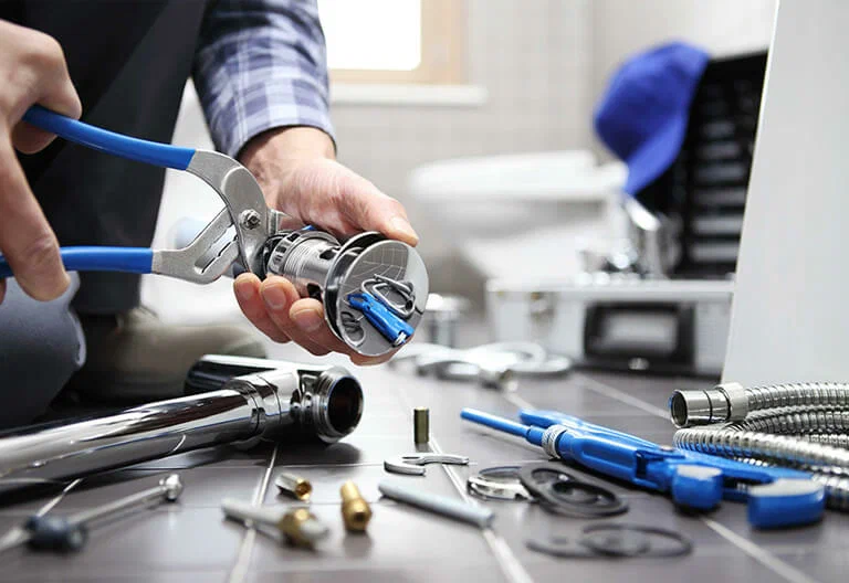 Technician repairing a plumbing fixture with professional tools in Rockledge