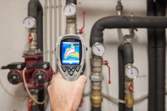 Plumber using a thermal imaging camera to inspect pipes in Rockledge