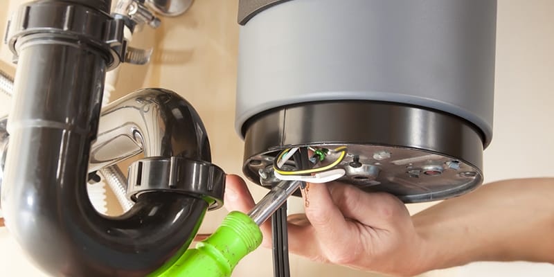 Technician repairing the heating element of a water heater in Rockledge