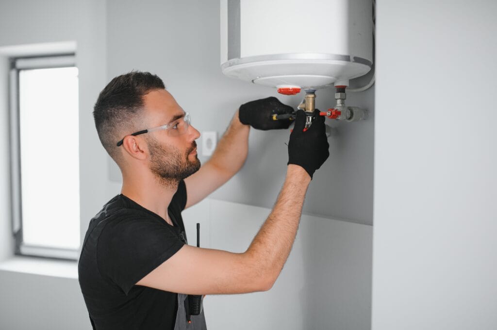 Technician performing water heater maintenance in Rockledge