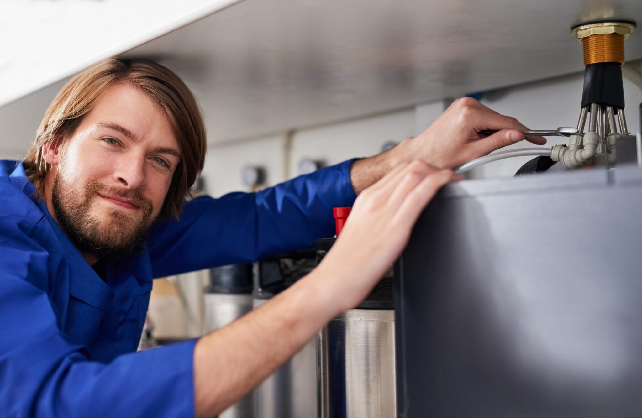 Technician servicing a residential water heater tank in Rockledge