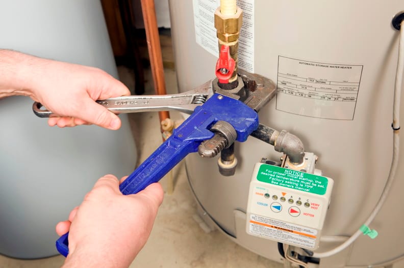 Plumber repairing a water heater valve in Rockledge
